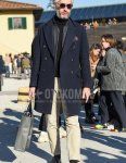 Men's fall/winter coordinate and outfit with solid black sunglasses, solid navy chester coat, solid dark gray inner down, solid black turtleneck knit, solid beige chinos, solid beige ankle pants, solid black socks, and black coin loafer leather shoes.