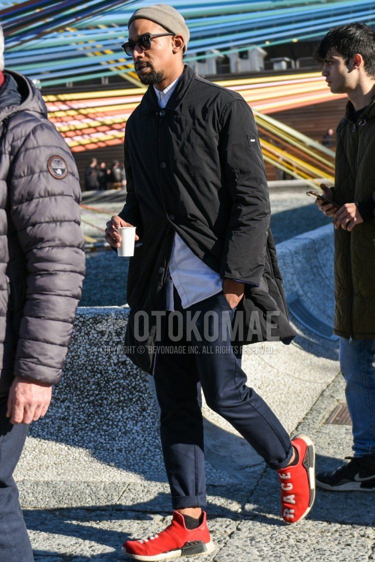 Men's fall/winter coordinate and outfit with plain gray knit cap, plain black sunglasses, plain black outerwear, plain white shirt, plain navy slacks, and Adidas NMD red low-cut sneakers.
