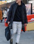 Men's fall/winter outfit with solid black sunglasses, solid black hooded coat, solid black hoodie, solid white cotton pants, black work boots, and solid black briefcase/handbag.