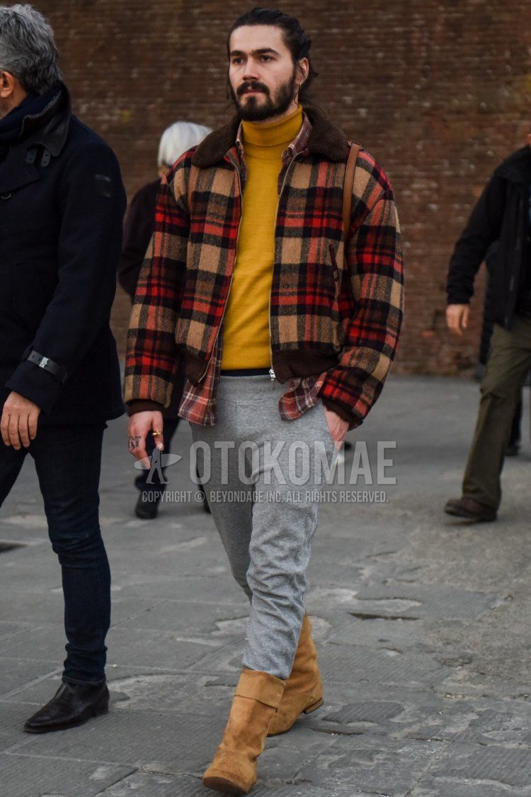 Men's fall/winter outfit and outfit with beige/brown checked outerwear, plain beige turtleneck knit, plain gray sweatpants, and beige boots.