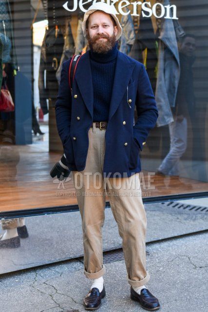 Men's fall/winter coordinate and outfit with plain navy tailored jacket, plain navy turtleneck knit, plain brown mesh belt, plain brown leather belt, plain beige chinos, plain white socks, and black coin loafer leather shoes.