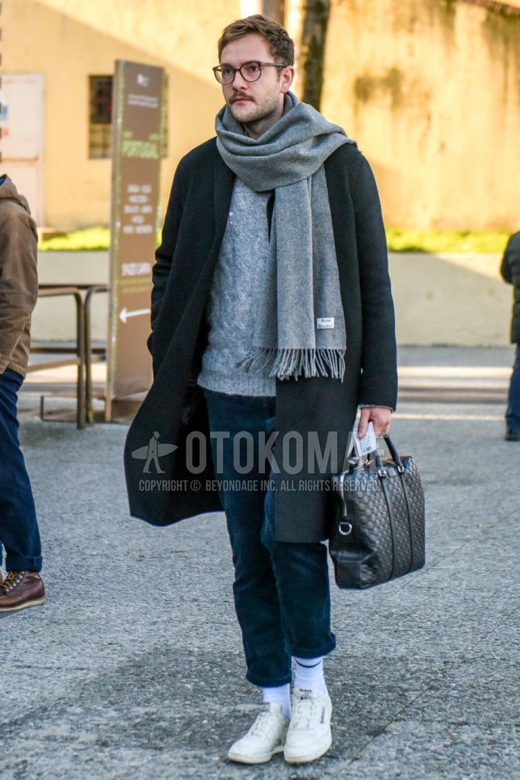 Men's fall/winter outfit with brown tortoiseshell glasses, solid gray scarf/stall, solid black chester coat, solid gray sweater, solid navy chinos, solid white socks, Reebok white low-cut sneakers, black bag briefcase/handbag .