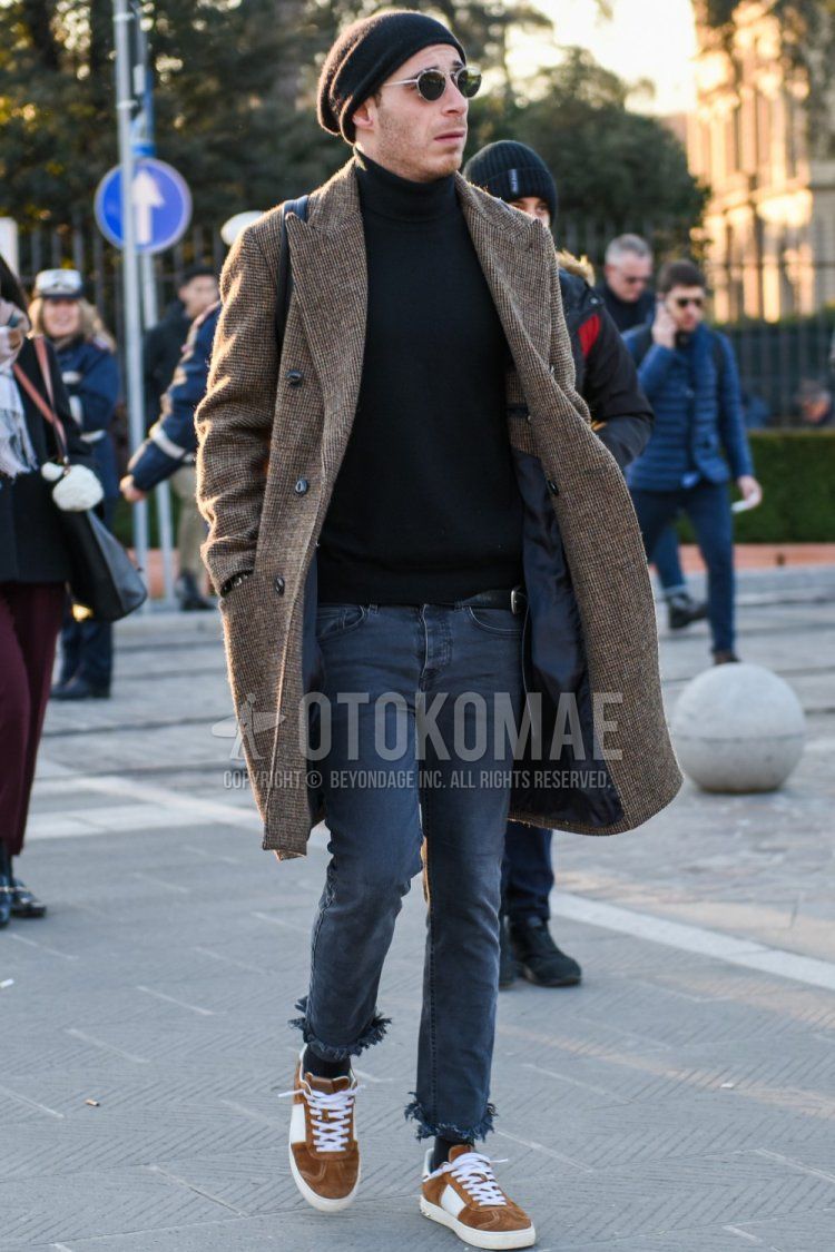 Men's fall/winter outfit with solid black knit cap, solid silver sunglasses, solid beige chester coat, solid black turtleneck knit, solid dark gray denim/jeans, solid dark gray ankle pants, solid black socks, brown low-cut sneakers Outfit.