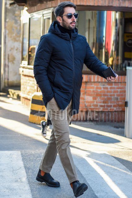 Men's fall/winter coordinate and outfit with clear solid sunglasses, solid navy down jacket, solid black turtleneck knit, solid beige chinos, and black side gore boots.