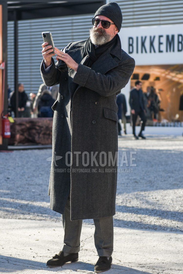 Men's fall/winter outfit with plain gray knit cap, plain black sunglasses, plain black scarf/stall, plain gray Ulster coat, plain gray slacks, plain gray socks, gray tassel loafers leather shoes, gray suede shoes leather shoes.
