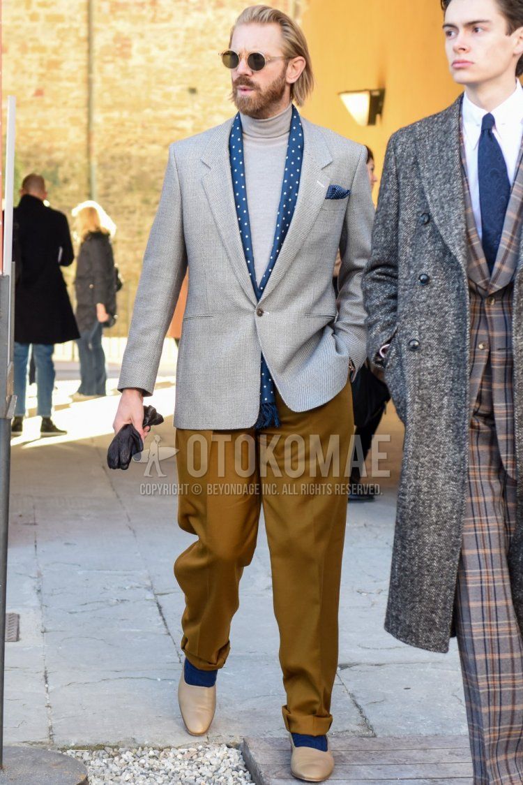 Spring and fall men's outfit with clear solid sunglasses, navy-dot scarf/stall, solid gray tailored jacket, solid gray turtleneck knit, solid beige chinos, solid beige pleated pants, solid navy socks, beige loafer leather shoes Outfit.