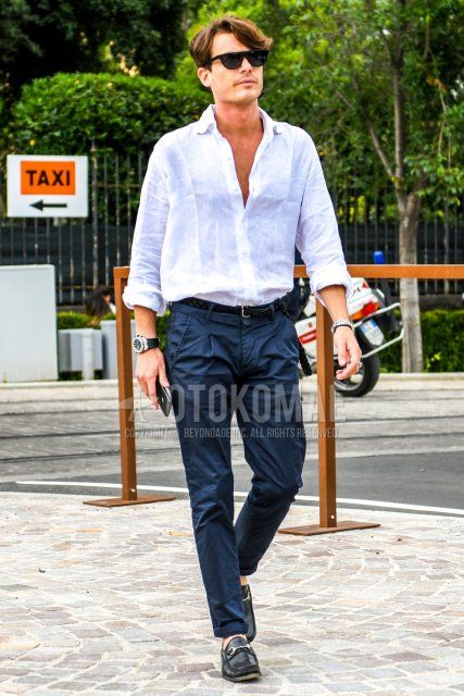 Men's spring/summer coordinate and outfit with plain sunglasses, plain white shirt, plain black leather belt, plain navy pleated pants, plain chinos, and black bit loafer leather shoes.