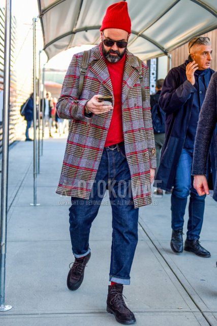 Men's fall/winter coordinate and outfit with red solid knit cap, brown tortoiseshell sunglasses, gray checked Ulster coat, red solid turtleneck knit, black solid leather belt, blue solid denim/jeans, red solid socks, brown boots.