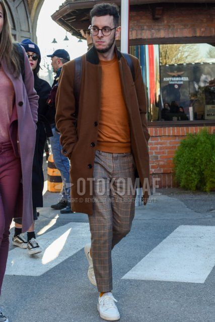 Men's fall/winter coordinate and outfit with brown tortoiseshell glasses, plain brown chester coat, plain beige sweater, gray checked slacks, gray checked ankle pants, plain beige socks, and white low-cut Adidas sneakers.