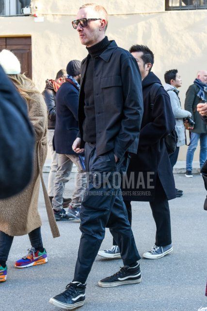 Men's fall/winter coordinate and outfit with plain black sunglasses, plain dark gray shirt jacket, plain black turtleneck knit, plain dark gray cargo pants, and black high-cut sneakers by Vans.