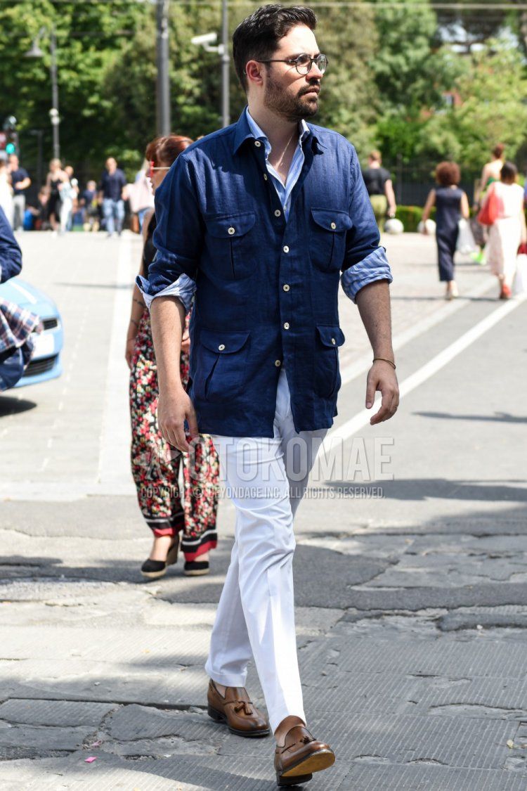 Men's spring, summer, and fall coordinate and outfit with plain black glasses, plain navy shirt jacket, light blue striped shirt, plain white cotton pants, and brown tassel loafer leather shoes.