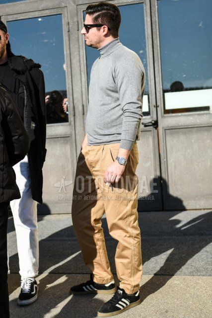 Men's spring and fall coordinate and outfit with plain black sunglasses, plain gray turtleneck knit, plain beige chinos, and Adidas Campus black low-cut sneakers.