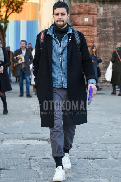 Men's fall/winter outfit with solid black chester coat, solid light blue denim jacket, solid gray turtleneck knit, solid gray cotton pants, solid dark gray socks, and white low-cut Reebok sneakers.