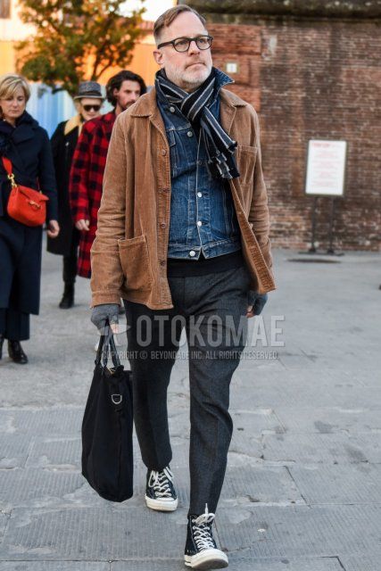 Solid black glasses, gray striped scarf/stall, solid brown outerwear, solid blue denim jacket, solid gray slacks, solid gray cropped pants, Converse All Star black high cut sneakers, solid black briefcase/handbag. Men's fall/winter outfits/coordinates.