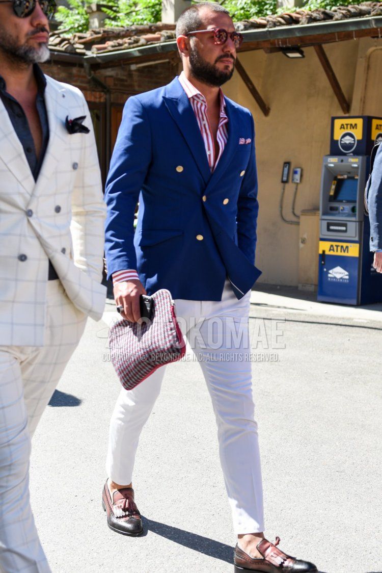 Men's spring/autumn outfit with red plain sunglasses, navy plain tailored jacket, red striped shirt, white plain cotton pants, brown/black tassel loafer leather shoes, red checked clutch bag/second bag/drawstring.
