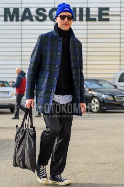 Men's fall/winter outfit with solid blue knit cap, solid black sunglasses, olive green/blue checked stainless coat, solid black turtleneck knit, solid gray slacks, black high-cut Converse sneakers, and solid black briefcase/handbag. Outfit.