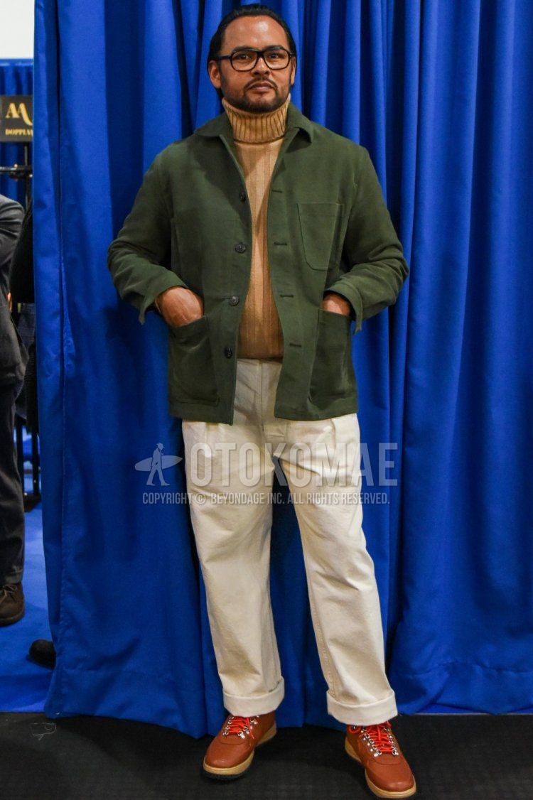 Men's spring and fall coordinate and outfit with plain black glasses, plain olive green shirt jacket, plain beige turtleneck knit, plain white cotton pants, and brown boots.
