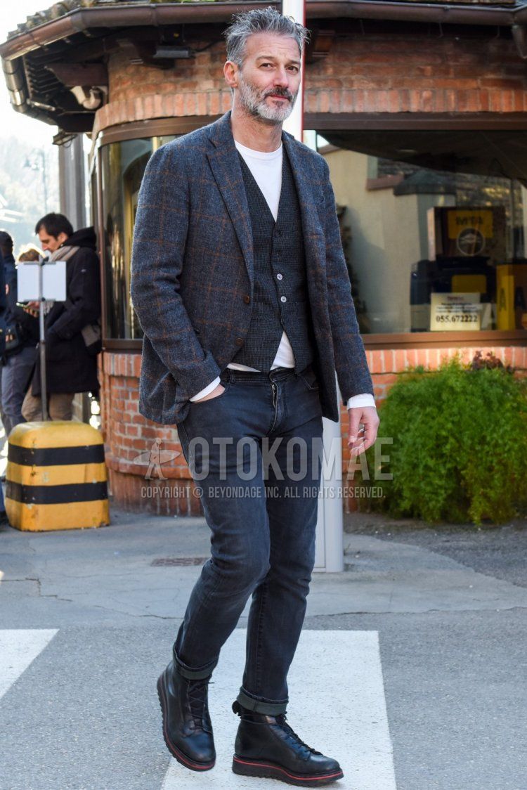 Men's spring/autumn coordination and outfit with gray checked tailored jacket, gray checked gilet, plain white t-shirt, plain gray denim/jeans, and black boots.