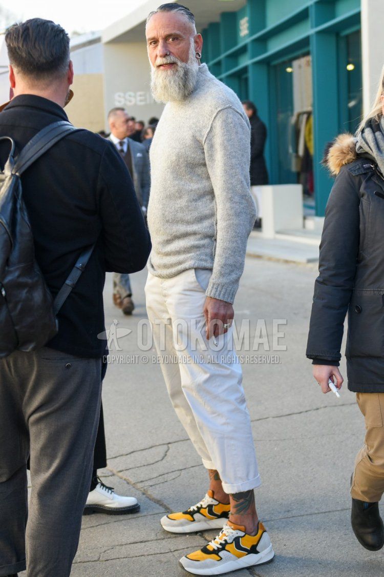Men's spring and fall coordinate and outfit with plain gray turtleneck knit, plain white cotton pants, and yellow-cut sneakers.