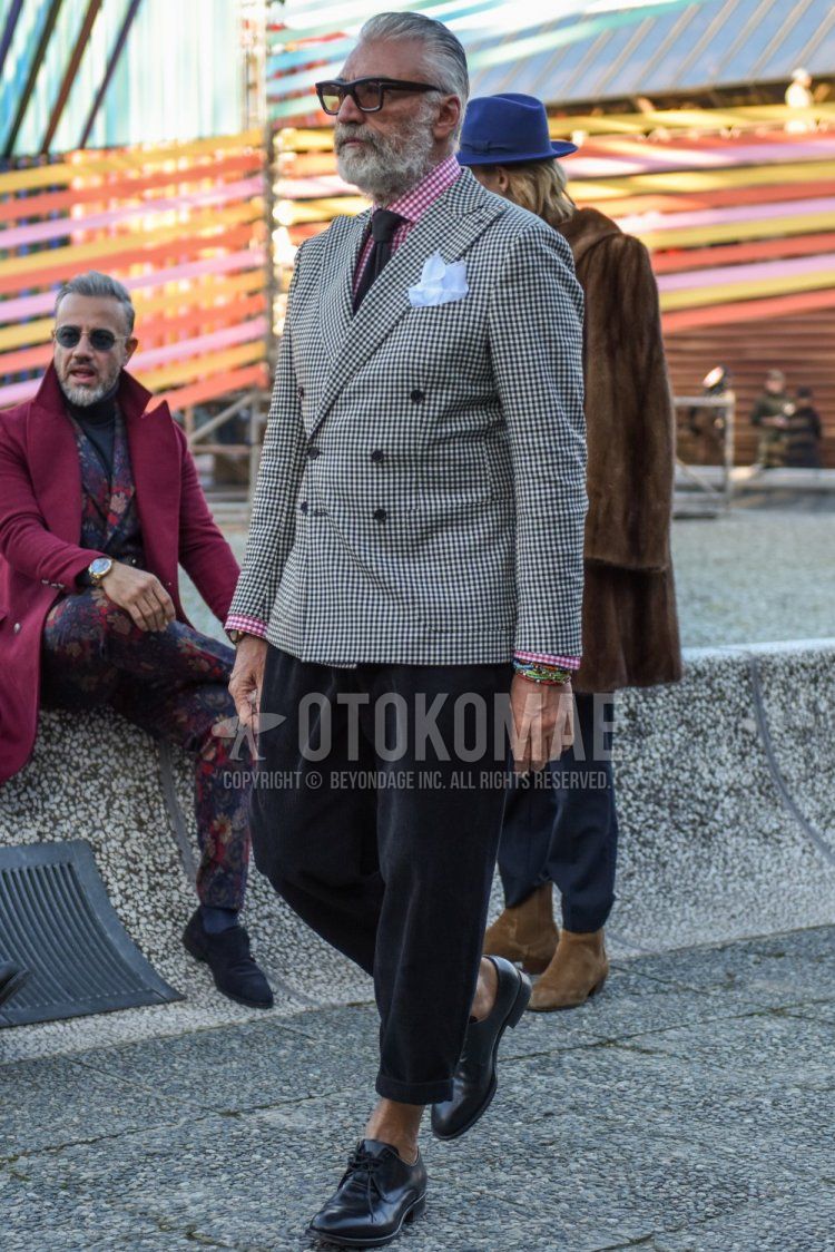 Men's spring and fall outfit with plain black Tom Ford glasses, white and black checked tailored jacket, red and white checked shirt, plain gray slacks, black plain toe leather shoes, and plain gray knit tie.