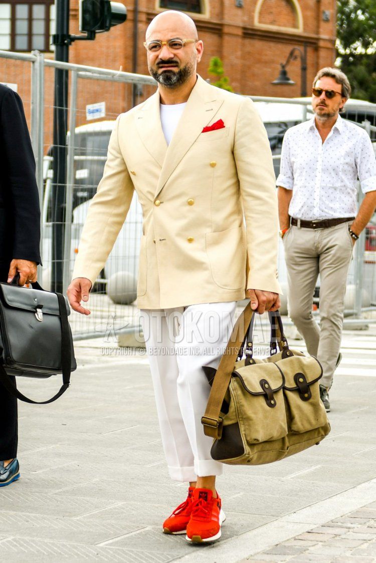 Men's spring, summer, and fall coordinate and outfit with plain glasses, plain beige tailored jacket, plain white t-shirt, plain white pleated pants, Adidas Iniki Runner red low-cut sneakers, and plain beige shoulder bag.
