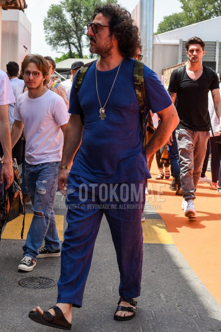 Men's summer coordinate and outfit with dark gray solid color T-shirt, dark gray solid color slacks, and black leather sandals.