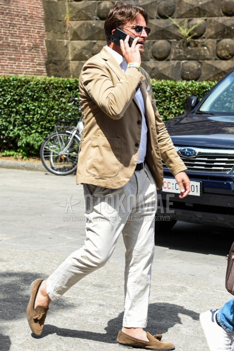 Men's spring, summer, and fall outfits and outfits with plain black sunglasses, plain beige tailored jacket, plain white shirt, plain black leather belt, plain beige chinos, and suede beige tassel loafer leather shoes.