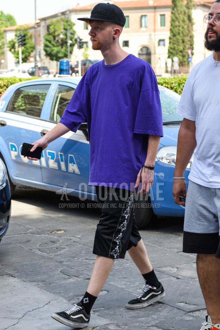 Summer men's coordinate and outfit with Dsquared solid black baseball cap, solid purple t-shirt, Kappa solid black shorts, solid black socks, and Vans black low-cut sneakers.
