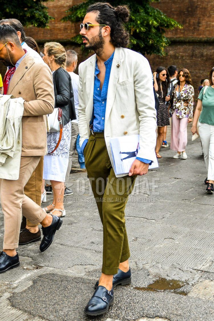 Solid yellow/clear sunglasses, solid white tailored jacket, solid light blue denim/chambray shirt with band collar, solid navy suspenders, solid olive green cargo pants, solid olive green cropped pants, solid olive green slacks, Navy monk leather shoes, spring, summer, and fall men's coordinate and outfit.