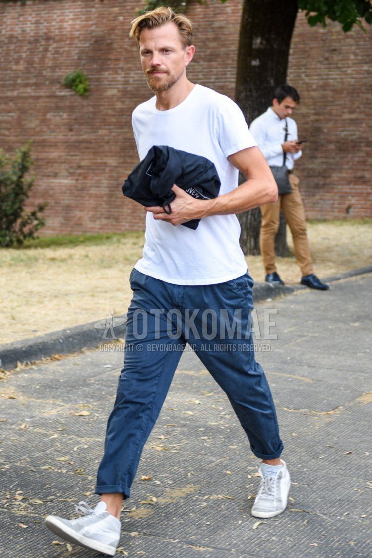 Men's summer coordinate and outfit with plain white T-shirt, plain blue cotton pants, and white high-cut sneakers.