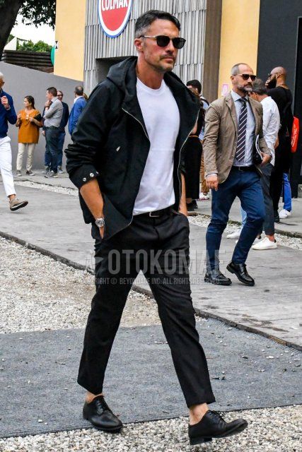 Men's spring, summer, and fall outfits and outfits with plain black sunglasses, plain black hoodie, plain white t-shirt, plain black leather belt, plain black ankle pants, and black plain-toe leather shoes.