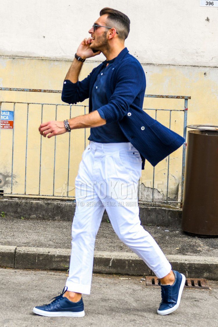 Men's spring, summer, and fall coordinate and outfit with plain blue tailored jacket, plain blue T-shirt, plain white pleated pants, plain slacks, and blue low-cut sneakers.