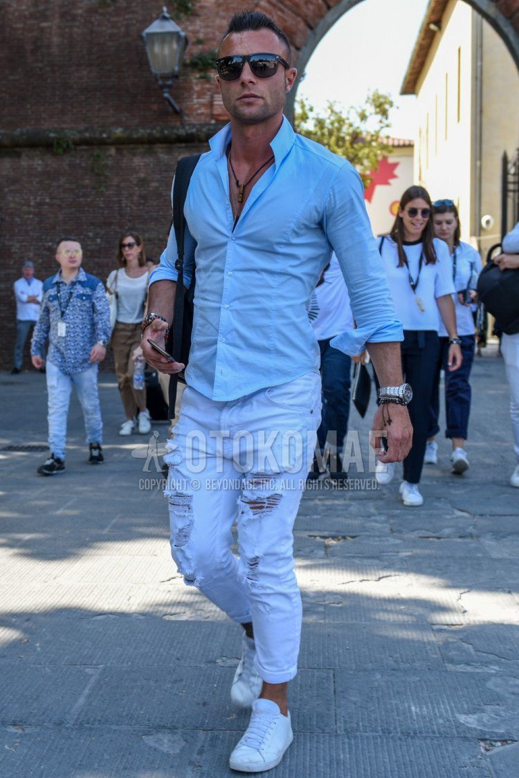Men's spring, summer, and fall coordination and outfit with plain black sunglasses, plain light blue shirt, plain white damaged jeans, and white low-cut sneakers.