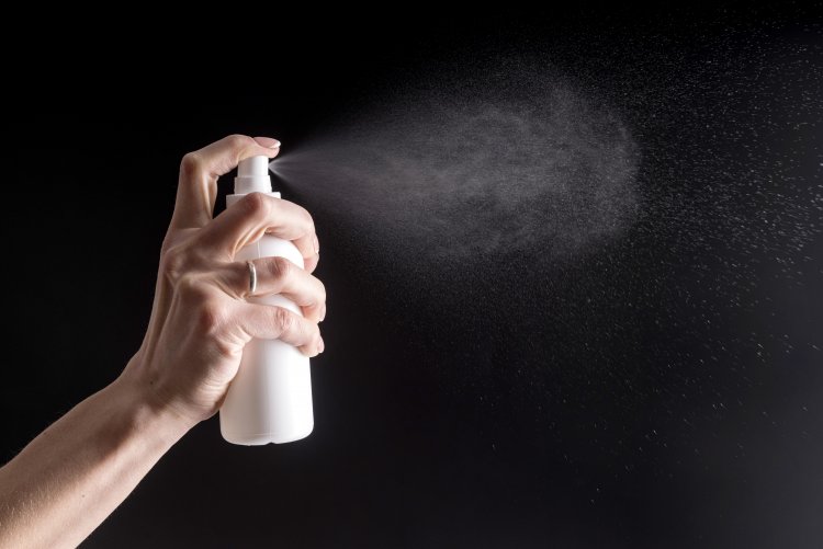 How do I use waterproof spray effectively and how often?