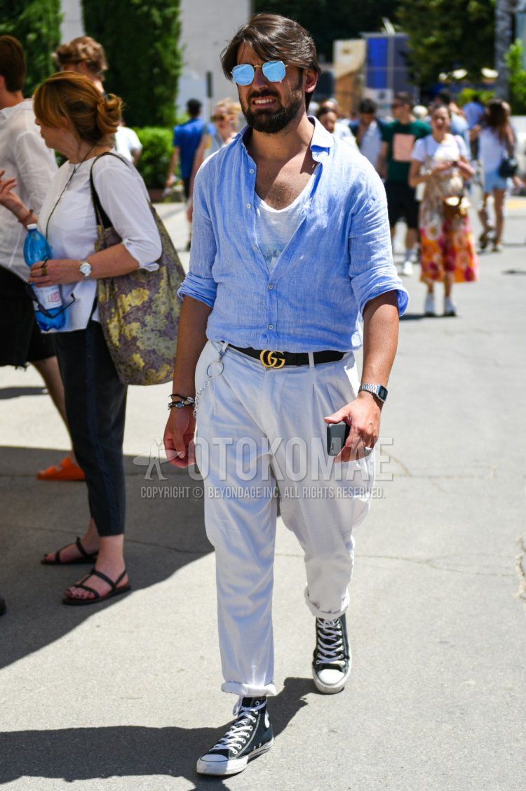 Men's spring, summer, and fall coordinate and outfit with plain blue sunglasses, plain light blue shirt, plain white t-shirt, plain black leather belt by Gucci, and black high-cut sneakers by Converse.