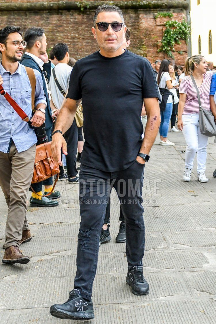 Men's summer coordinate and outfit with Ray-Ban Boston plain black sunglasses, plain black t-shirt, plain black damaged jeans and black low-cut sneakers from Premiata.