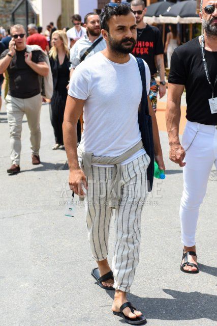 Men's spring and summer coordinate and outfit with plain black sunglasses, plain white t-shirt, plain white easy pants, and black flip flops.