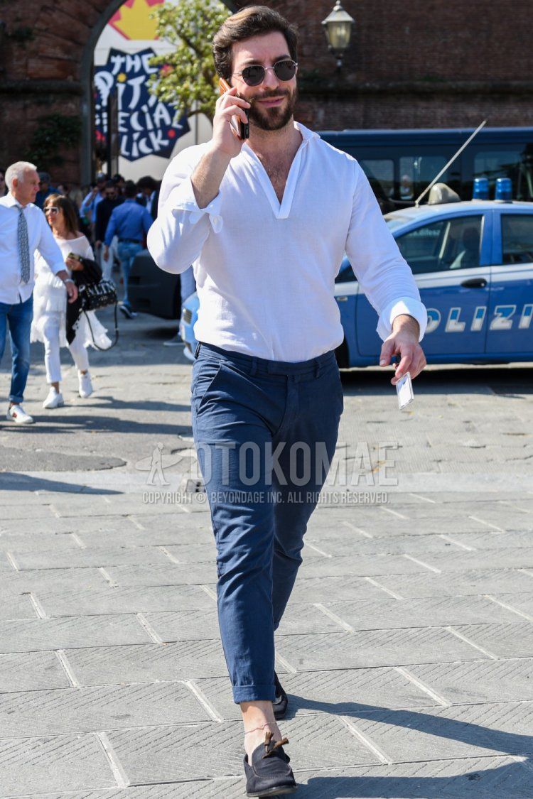 Men's spring, summer, and fall coordinate and outfit with round plain silver sunglasses, linen pullover plain white shirt, plain blue cotton pants, and suede navy tassel loafer leather shoes.
