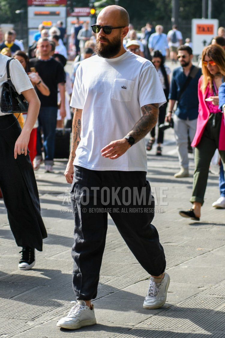 Men's summer coordinate and outfit with plain sunglasses, plain white t-shirt, plain black cargo pants, and white low-cut sneakers.