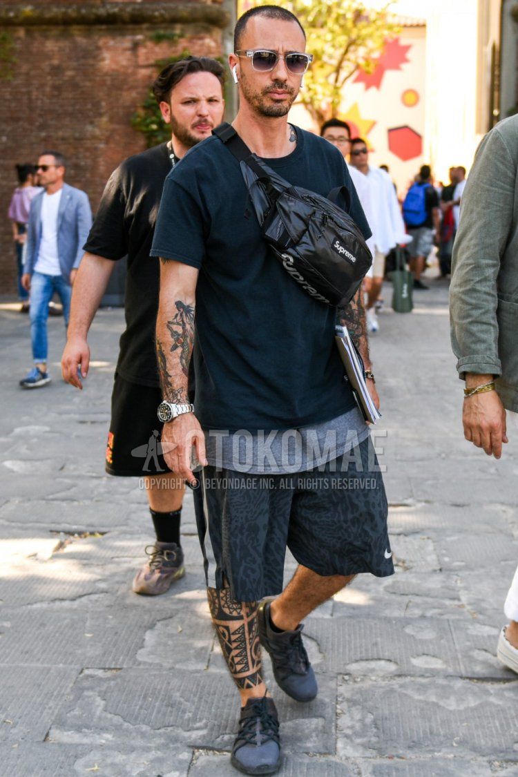 Summer men's coordinate and outfit with clear plain sunglasses, plain black t-shirt, plain gray t-shirt, Nike gray bottoms shorts, Nike gray bottoms sideline pants, gray low-cut sneakers, Supreme black one-pointed sacoche.