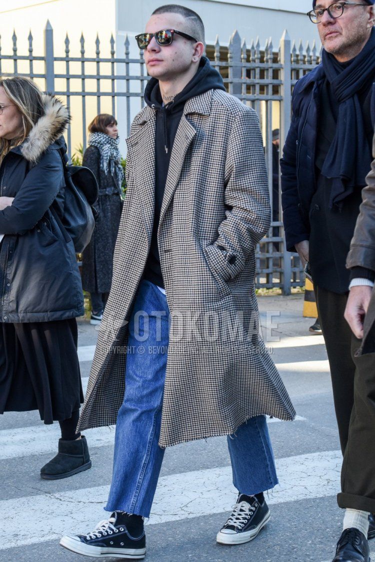 Men's fall/winter outfit with plain black Wellington sunglasses, gray checked stainless coat, plain black hoodie, solid blue cropped pants, solid blue denim/jeans, solid black socks, and Converse Chuck Taylor black low-cut sneakers.