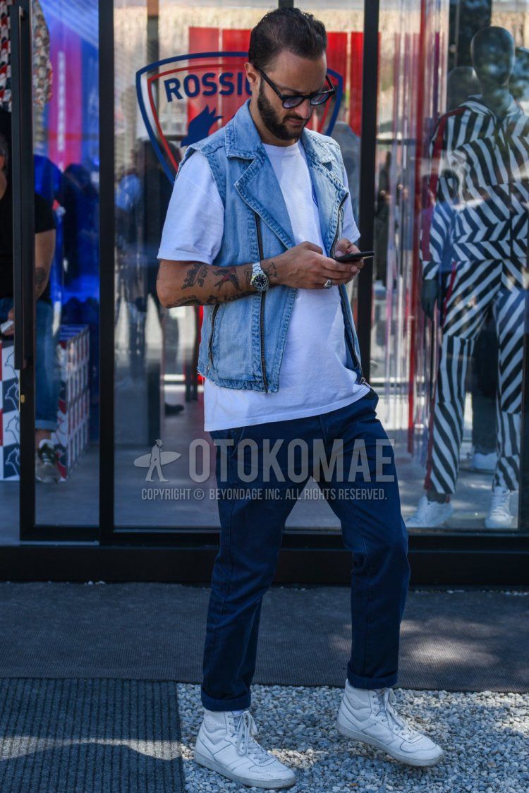 Men's spring/summer coordinate and outfit with plain black sunglasses, plain light blue casual vest, plain white t-shirt, plain navy cotton pants, and white high-cut sneakers.