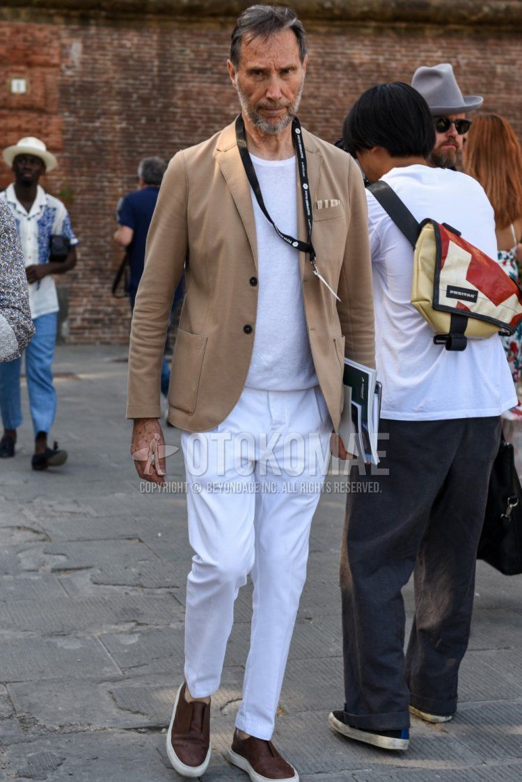 Men's spring, summer, and fall coordinate and outfit with plain brown tailored jacket, plain white T-shirt, plain white cotton pants, and brown slip-on sneakers.