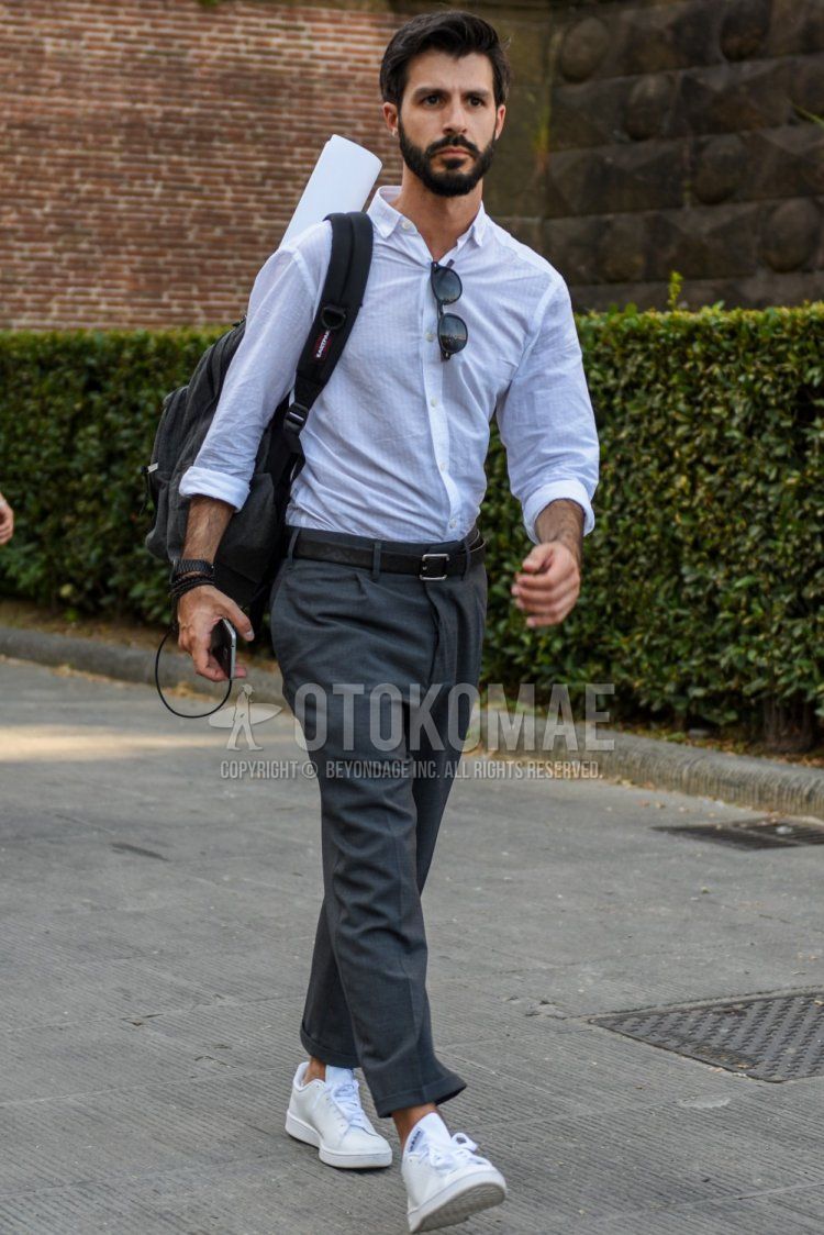 Men's spring/summer coordinate and outfit with plain white shirt, plain black leather belt, plain gray slacks, and white low-cut sneakers.