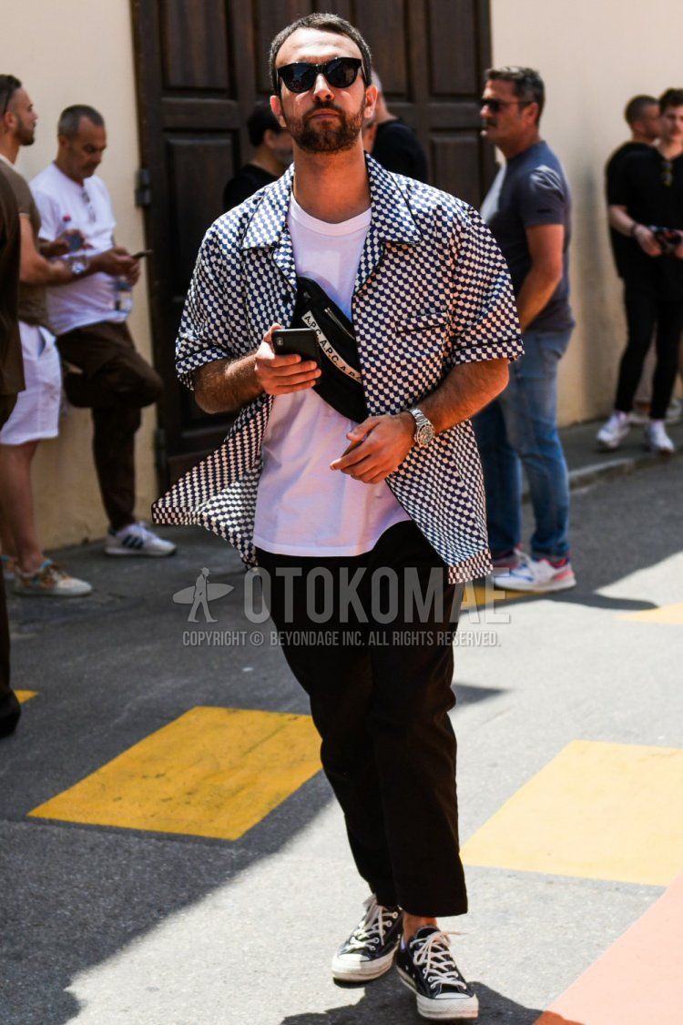 Men's summer coordinate and outfit with plain black sunglasses, short sleeve black/white top/inner shirt, short sleeve plain white t-shirt, plain black ankle pants, plain slacks, Converse All Star black low cut sneakers, A.P.C Arpesey plain black sacoche.