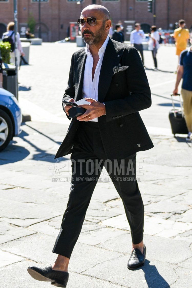 Men's spring, summer, and fall coordinate and outfit with teardrop black and gold plain sunglasses, plain black tailored jacket by Tagliatore, white striped shirt, plain black slacks, and black loafer leather shoes.