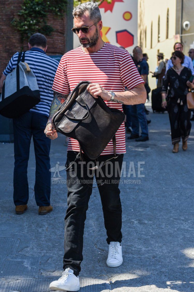 Summer men's coordinate/outfit with plain black/brown sunglasses, red/white striped t-shirt, plain black denim/jeans, white low-cut sneakers, and plain brown briefcase/handbag.