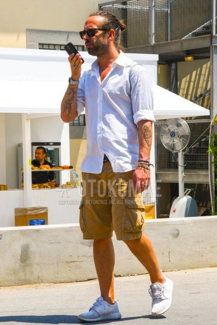 Men's spring/summer coordinate and outfit with Ray-Ban brown tortoiseshell sunglasses, plain white shirt, plain black mesh belt, plain beige shorts, plain beige cargo pants, and Nike Roshe One white low-cut sneakers.