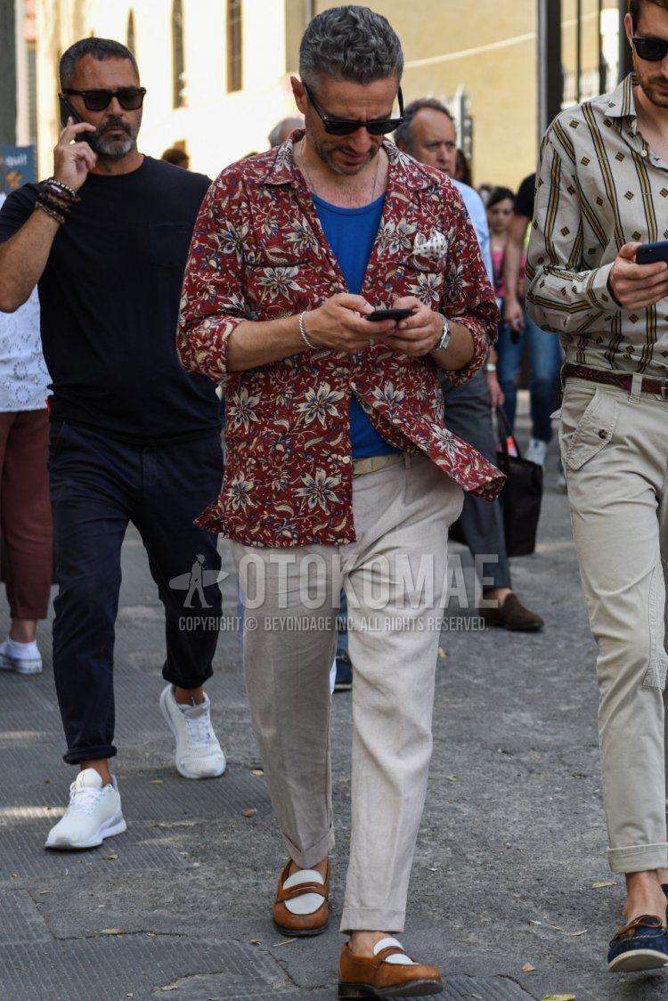 Men's spring, summer, and fall outfit with plain black sunglasses, red top/inner shirt, plain blue t-shirt, plain beige leather belt, plain linen beige slacks, plain beige ankle pants, and brown/white coin loafer leather shoes.
