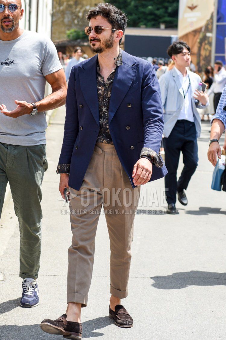 Men's spring, summer, and fall coordination and outfit with plain silver/black sunglasses, plain navy tailored jacket, black top/inner shirt, plain beige beltless pants, and brown coin loafer leather shoes.